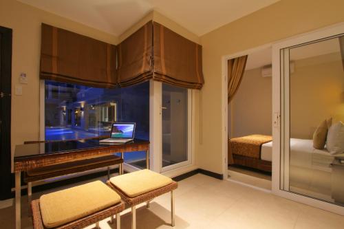 a bedroom with a desk with a laptop on it at Two Seasons Boracay Resort in Boracay