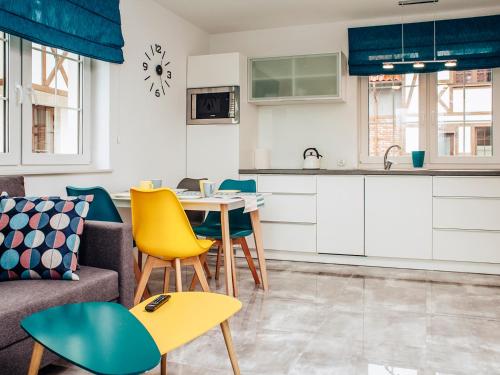 a kitchen and living room with a table and chairs at Kaszubskie Zacisze in Władysławowo