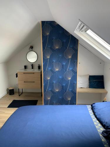 a bedroom with a blue bed and a blue wall at Le Phare de Cati in Mers-les-Bains