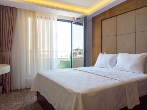 Ένα ή περισσότερα κρεβάτια σε δωμάτιο στο Bursa Ulupark Hotel