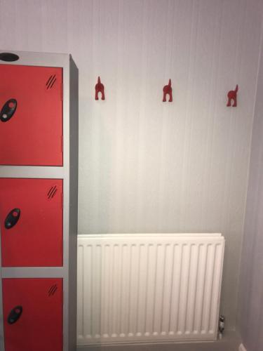 a room with red drawers and a radiator at Newcastle House Rothbury in Rothbury