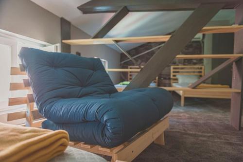 a blue couch sitting in the middle of a room at Temple House in Plovdiv