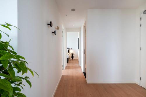 a hallway of a house with white walls and wood floors at PREMIER SUITES Amsterdam in Amsterdam