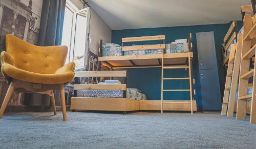 a room with bunk beds and a chair and a ladder at Temple House in Plovdiv