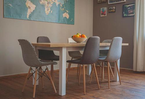 a table with chairs and a bowl of fruit on it at Temple House in Plovdiv