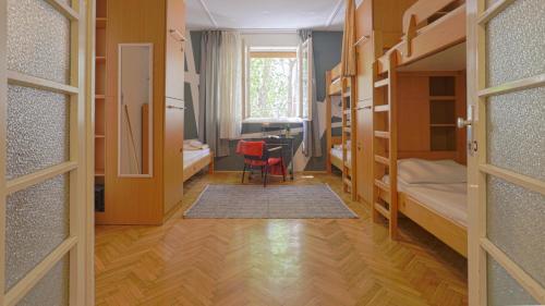 a room with a desk and a room with bunk beds at Tchaikovsky Hostel Split (T-Hostel) in Split