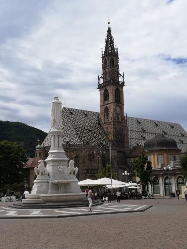 a large building with a clock tower in front of it at Marlingsuites - Vinea - Wieser Josef - Marling in Marlengo