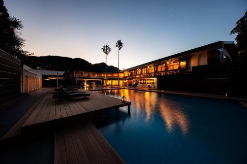 a building with a swimming pool in front of it at Seiryu-so in Shimoda