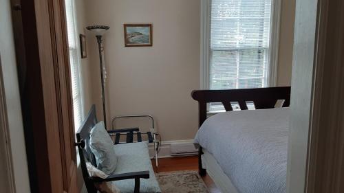 a bedroom with a bed and a lamp and a window at Sea Birds Cottage in Victoria