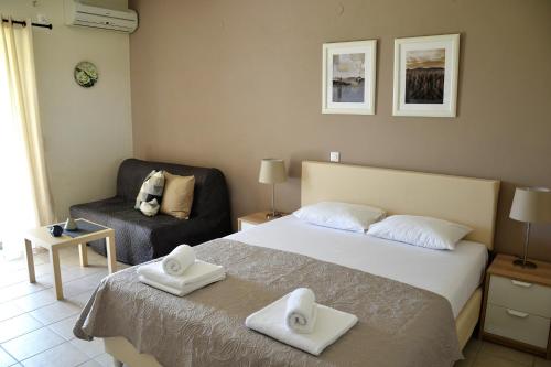 a hotel room with a bed and a chair at Villa Gianna in Apolpaina