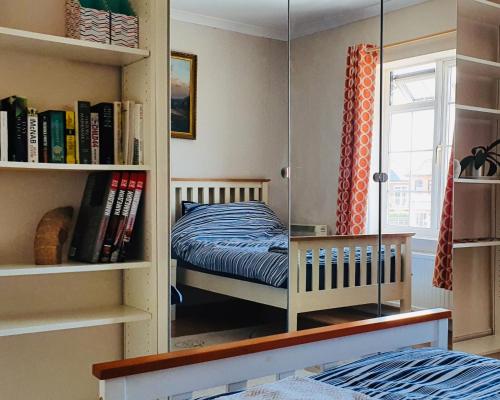 a bedroom with a bed in a book shelf at Brans Estate in West Mersea