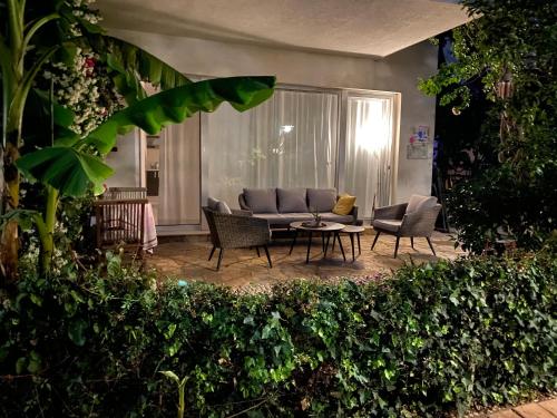 a living room with a couch and chairs and a table at Olives Terrace B2A5 Apartment in Dhërmi