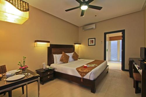 a bedroom with a bed and a ceiling fan at Two Seasons Boracay Resort in Boracay