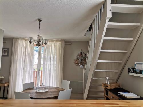 a dining room with a table and a staircase at Appartement Aline et Phil in Luz-Saint-Sauveur