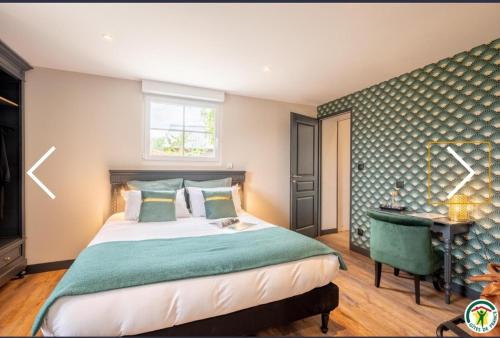 a bedroom with a bed and a desk and a window at ATELIER 19 Maison d'Hôtes in Varesnes
