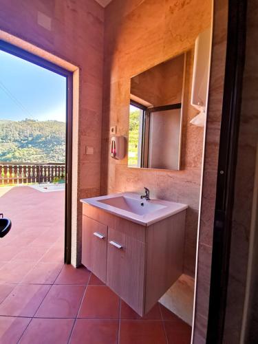 a bathroom with a sink and a mirror at Casa Carolina in Vila Seca