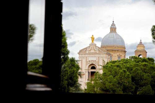 a large building with a dome on top of it at Hotel Donnini in Assisi
