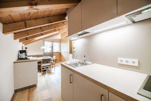 a kitchen with a sink and a counter top at Appartements Sporting in Sesto