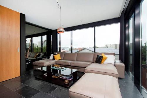 a living room with a couch and a table at Sunny and Spacious Luxury House in Reykjavík
