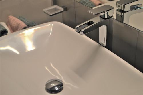 a white sink with a faucet in a bathroom at Triestè59 B&B in Trieste