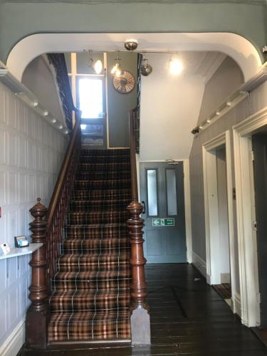 a spiral staircase in a building with a hallway at Newcastle House Rothbury in Rothbury