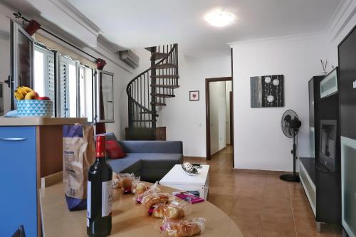 a living room with a table with a bottle of wine at Sardina Penthouse Dreams in Gáldar