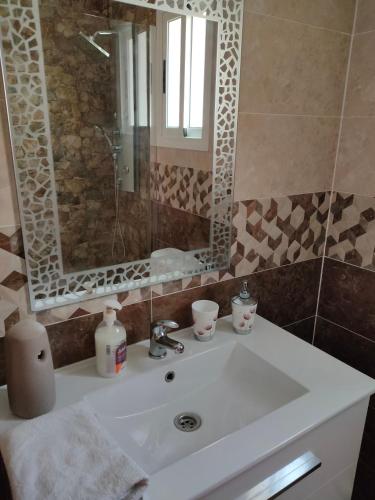 a bathroom with a sink and a mirror at Isabelita in Rota