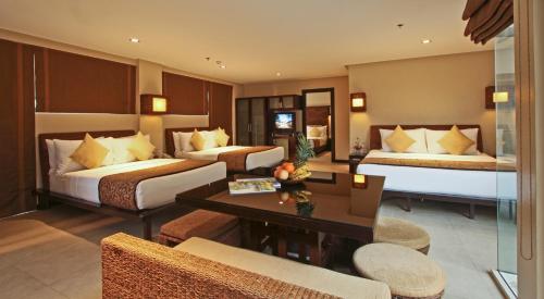 a hotel room with two beds and a table at Two Seasons Boracay Resort in Boracay