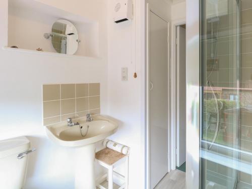 a bathroom with a sink and a shower at Primrose Cottage in Wells next the Sea