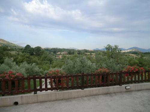 a wooden fence with flowers on top of a hill at Agriturismo Fiore in Viggianello