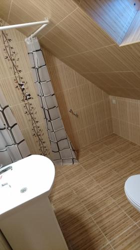 a bathroom with a white sink and a toilet at Bé-La 2 Vendégház in Szomolya