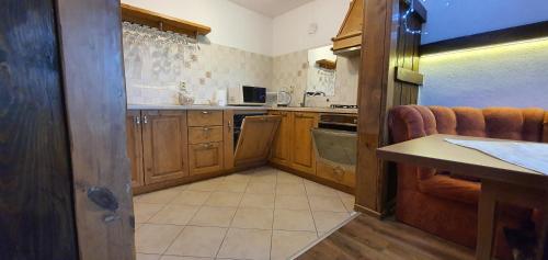 a kitchen with wooden cabinets and a counter top at Guest House Panorama in Gela