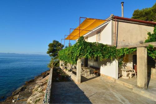 biały budynek z widokiem na ocean w obiekcie House Slavka w mieście Gdinj
