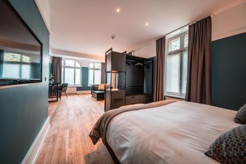 a hotel room with a bed and a desk at Royal St. Georges Hotel Interlaken - MGallery Collection in Interlaken