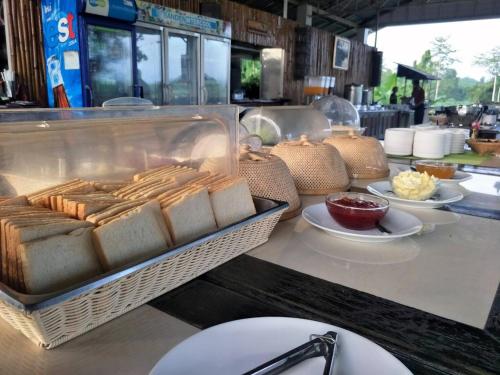 a buffet line with a tray of bread and other food at Nakakiri Resort & Spa in Hin Dat