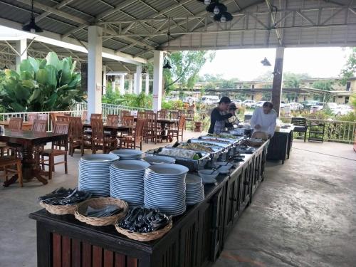a buffet with plates and bowls on a table at Nakakiri Resort & Spa in Hin Dat