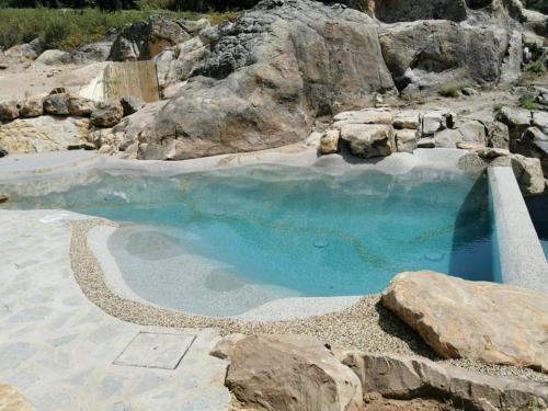 een zwembad met blauw water en rotsen bij Tambor Del Llano in Grazalema