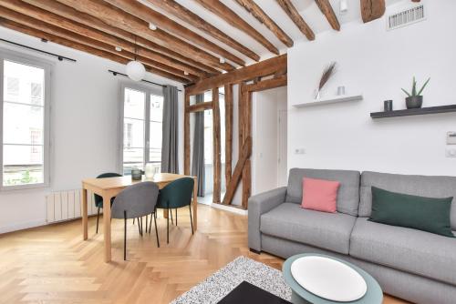 un salon avec un canapé et une table dans l'établissement Authentic apartment 1BR-4P République - Le Marais, à Paris