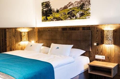 a hotel room with a bed and a table at Alpenhotel Wurzer in Filzmoos