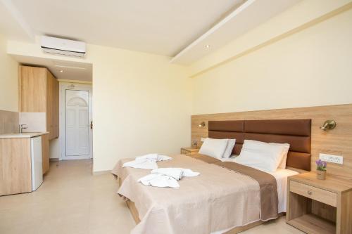 a bedroom with two beds with towels on them at Billy's Studios in Faliraki