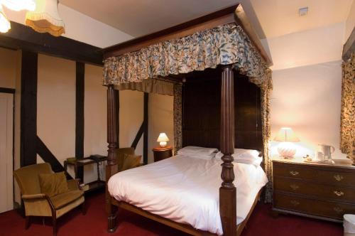 
a bedroom with a large bed and a large window at George & Pilgrims Hotel in Glastonbury
