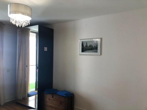 a room with a window and a picture on the wall at CK Serviced Apartments Belfast in Belfast