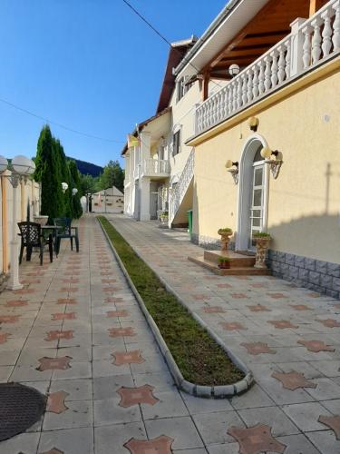 a walkway next to a building with stars on it at CAZARE LA ESPAÑOLA in Haţeg