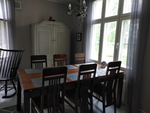 a dining room with a wooden table and chairs at Tohninmäen Talo in Töysä