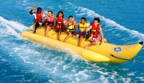 a group of children on a banana boat in the water at Seaview Chalets in Porto South Beach - Families only in Ain Sokhna