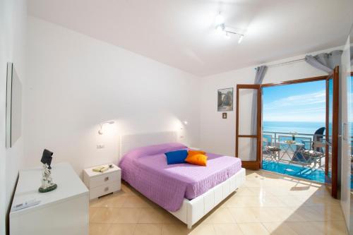 a bedroom with a bed and a view of the ocean at Domus Lavinia in Furore