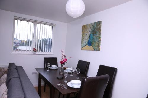 a living room with a table and a couch at The Penthouse (29) in Oldham