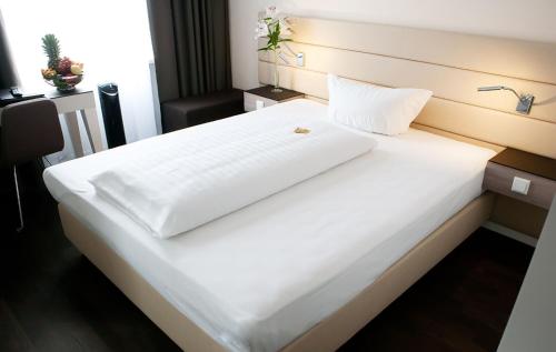 Postel nebo postele na pokoji v ubytování Manhattan Hotel