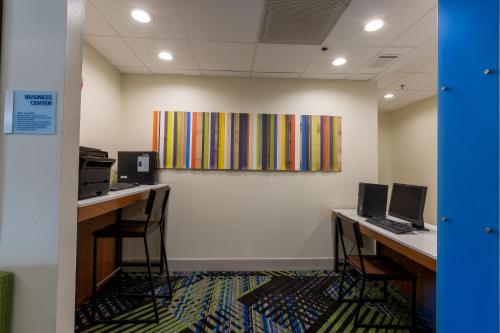 an office with two desks and two computers at Holiday Inn Express & Suites Arlington North – Stadium Area by IHG in Arlington