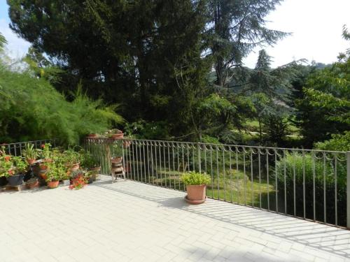 a metal fence with potted plants on a patio at MAMOTA B&B in Vesime